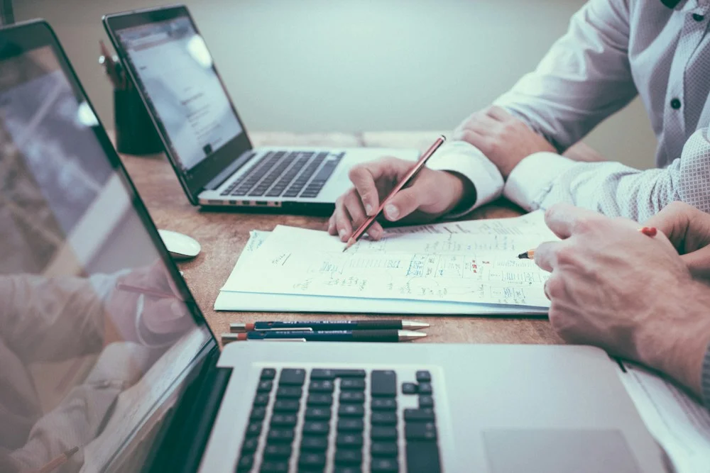 People reviewing documents together at a desk